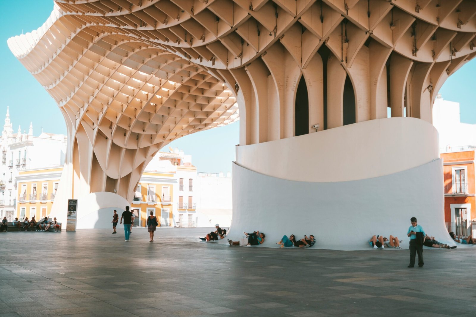 people under brown and white building